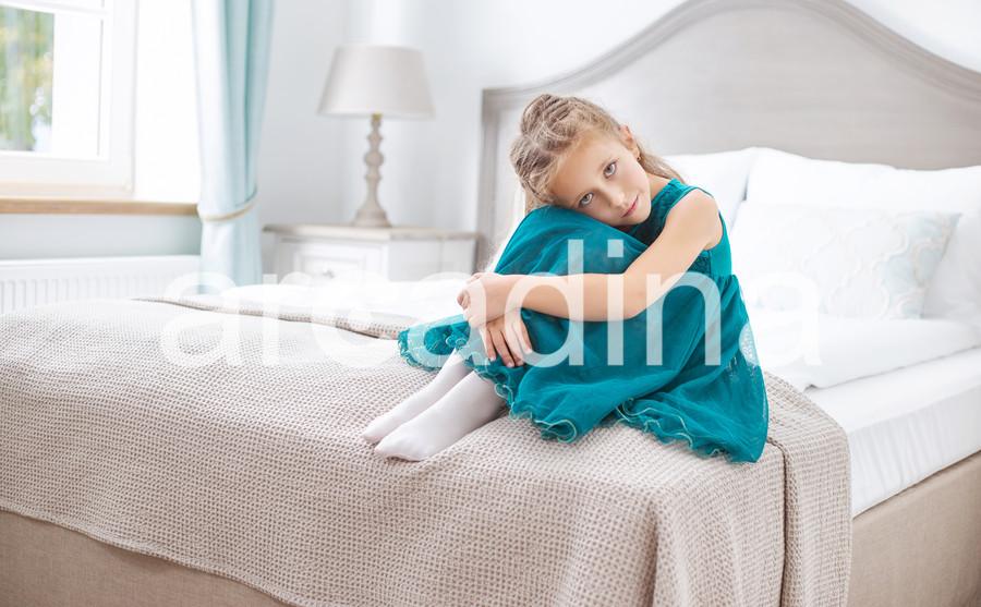 stockfresh_6559378_sad-young-girl-sitting-in-bedroom_sizeXL_84e148