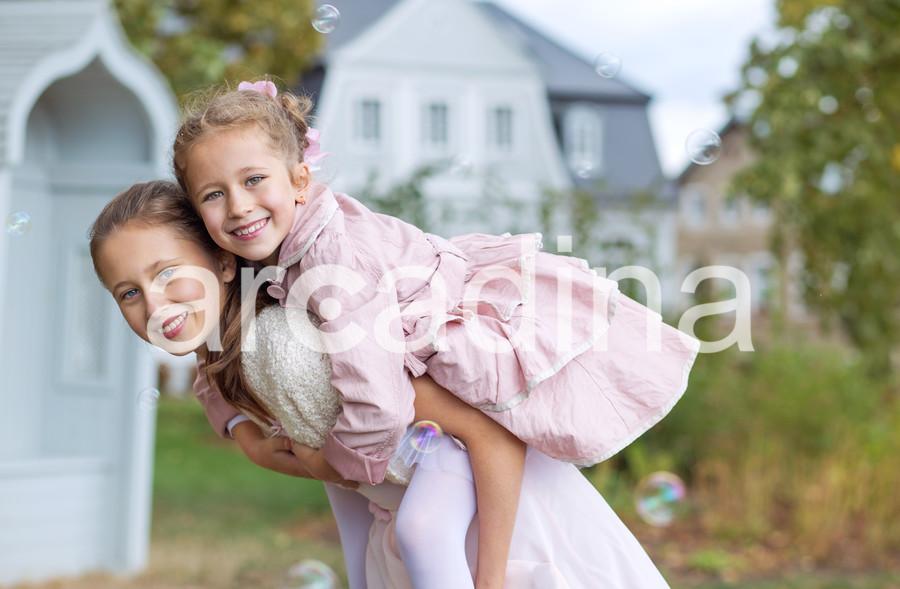stockfresh_6559351_two-cute-sisters-enjoying-the-autumn-garden_sizeXL_aa2c46